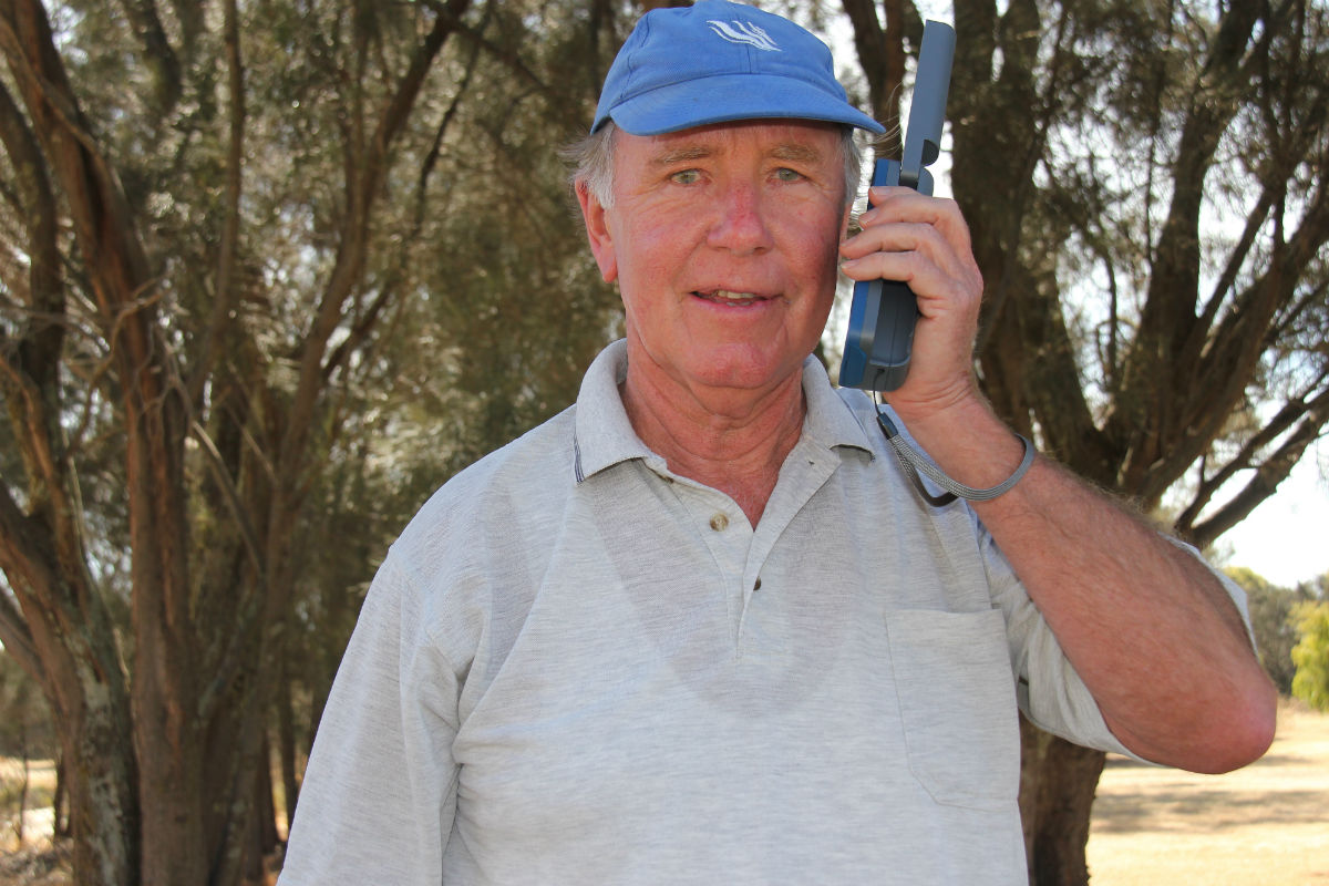 elderly man using a satellite mobile device