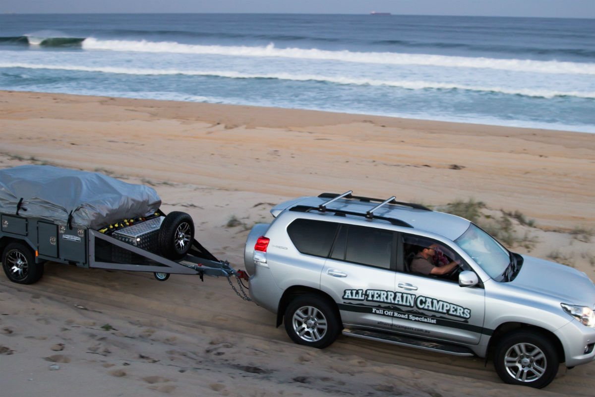 All terrains campers 4WD towing a trailer on the beach