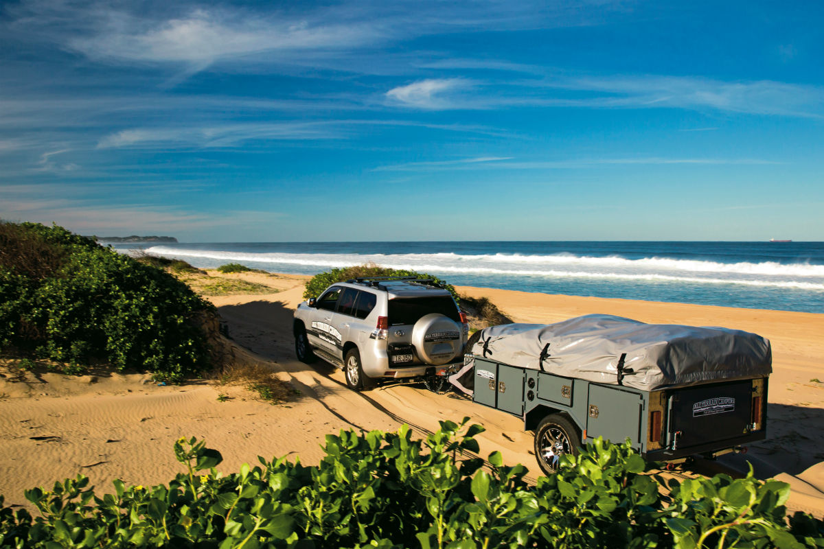 4WD towing a trailer on sand dunes near the beach