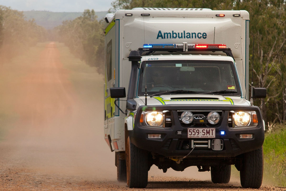 Ambulance travelling on dirt road in the outback