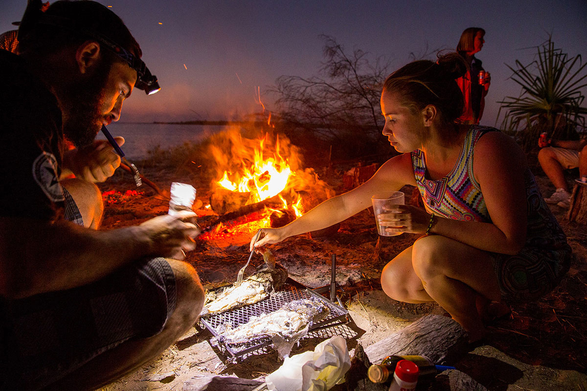 Group-of-people-eating-by-the-campfire-on-the-beach-at-the-Gibb-River-Road