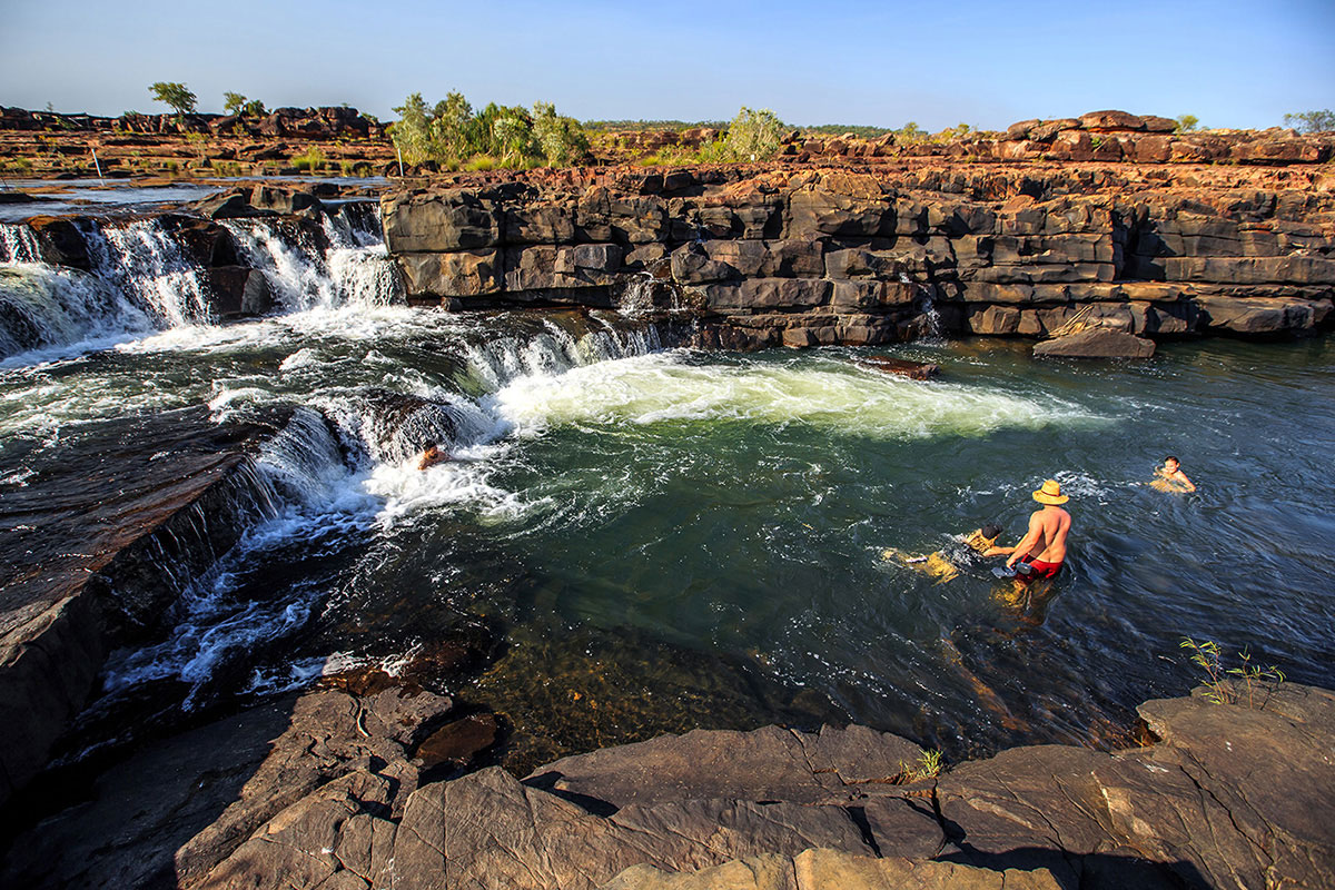 People-swimming-at-the-waterfall-at-the-Gibb-River-Road