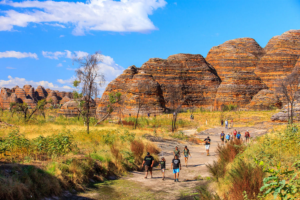 People-walking-next-to-rock-formations-at-the-Gibb-River-Road