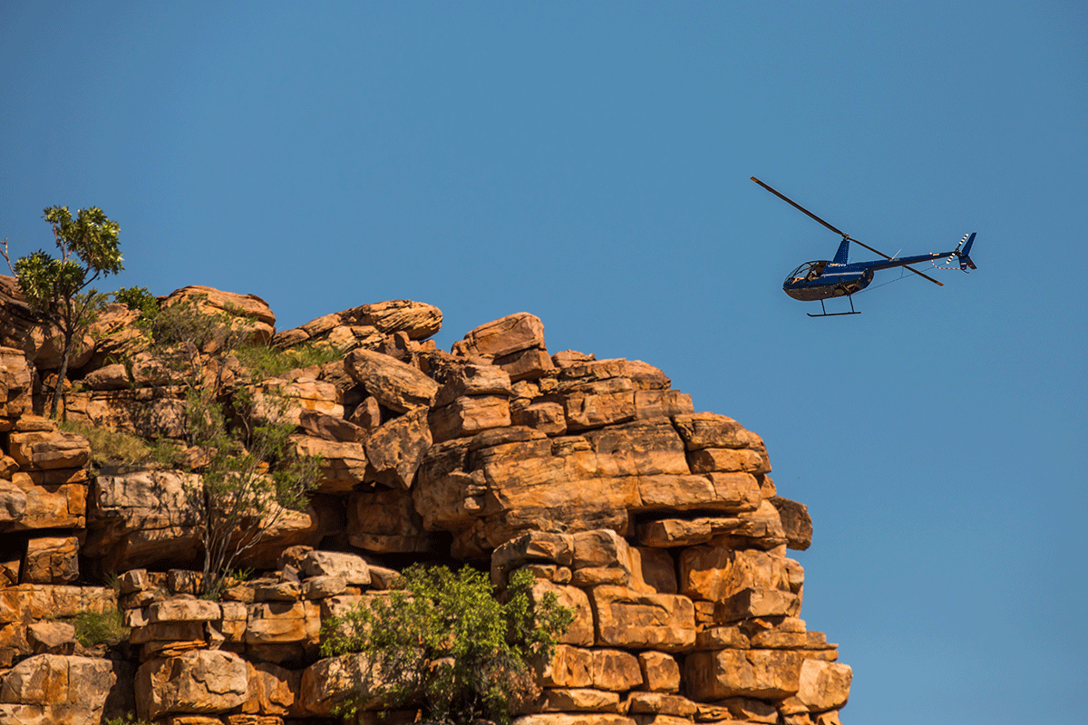 Helicopter-in-the-air-flying-over-mountains