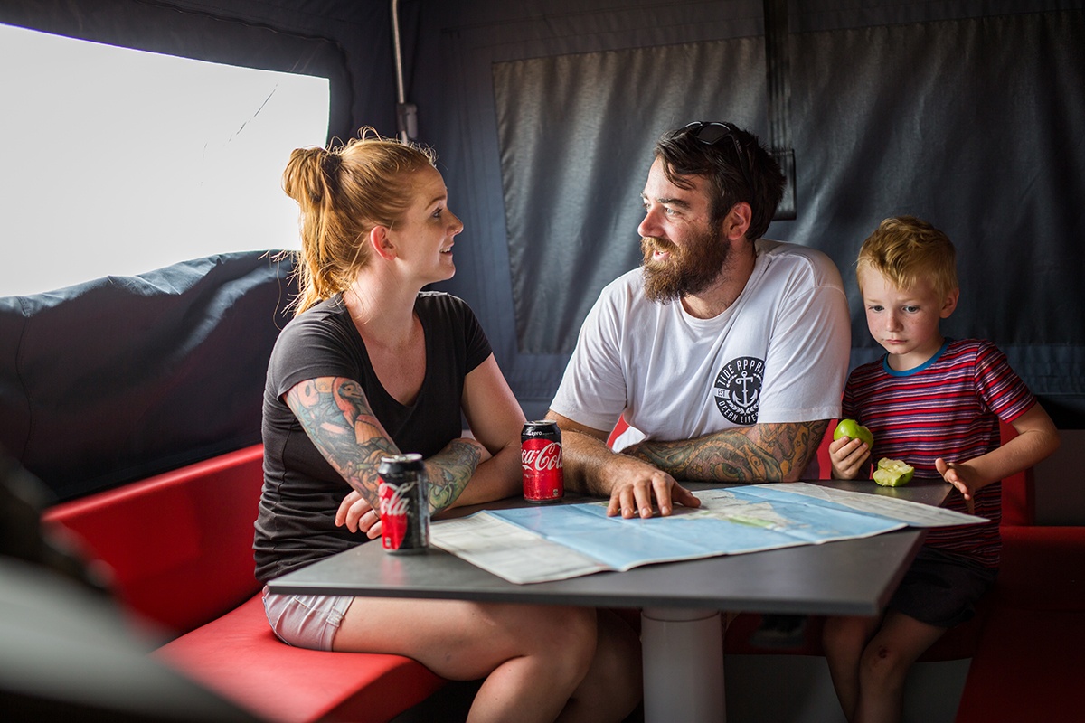 Family-sitting-inside-the-camper-trailer