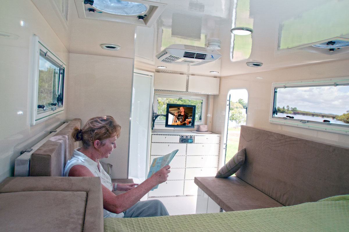 Woman-looking-at-the-map-inside-the-caravan